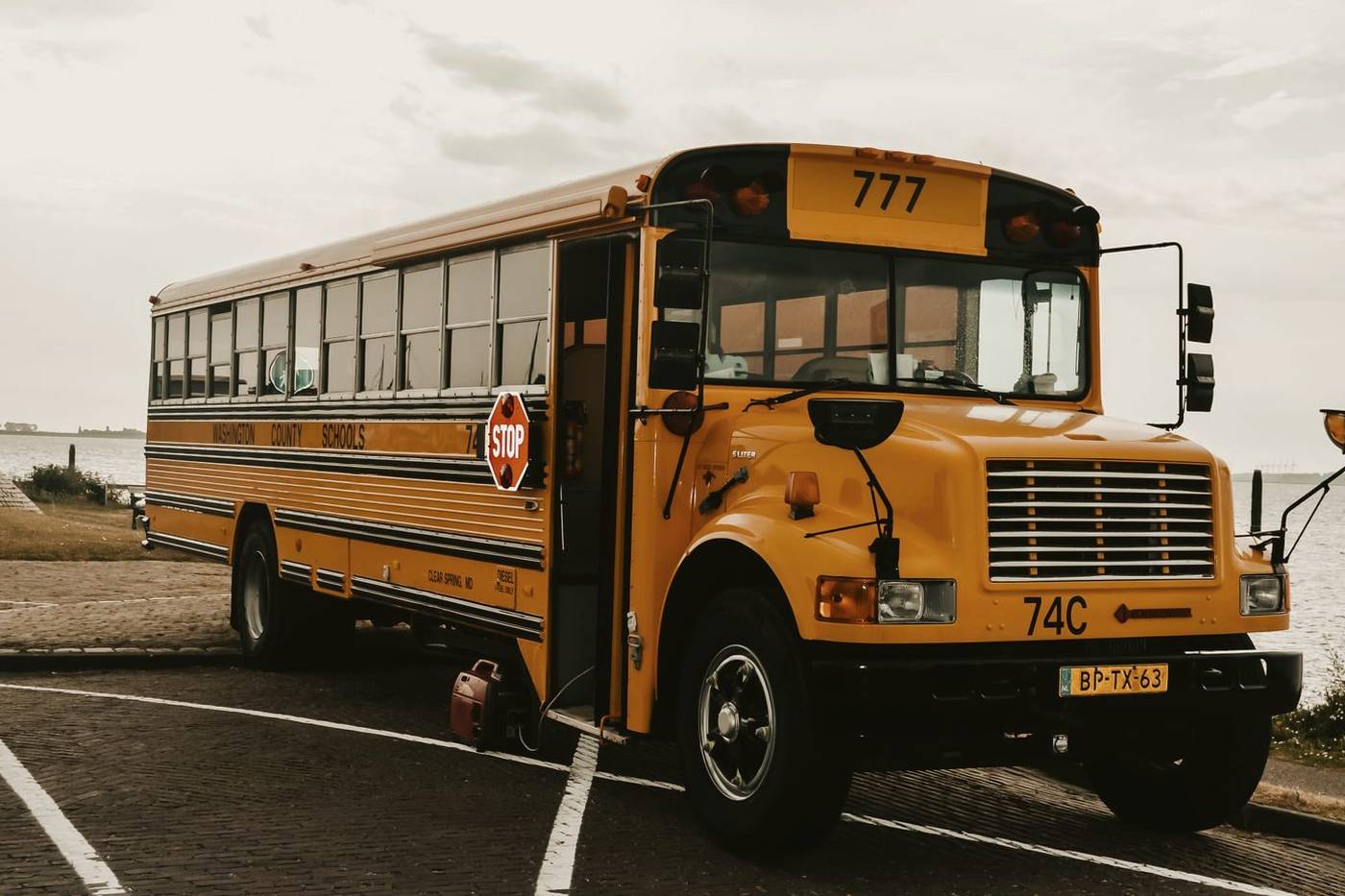 A yellow school bus parked at the roadside